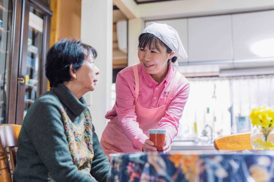 お客様と目線を合わせて話す介護スタッフ